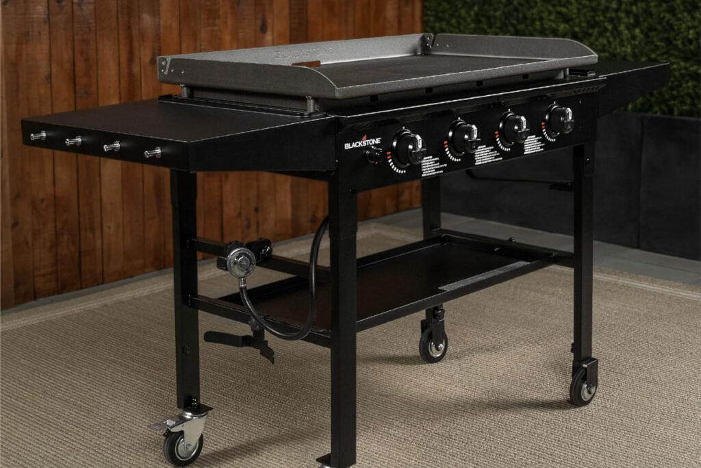 Blackstone 1554 36-Inch Omnivore Griddle showcased in a backyard setting, ideal for family gatherings and outdoor cooking adventures.