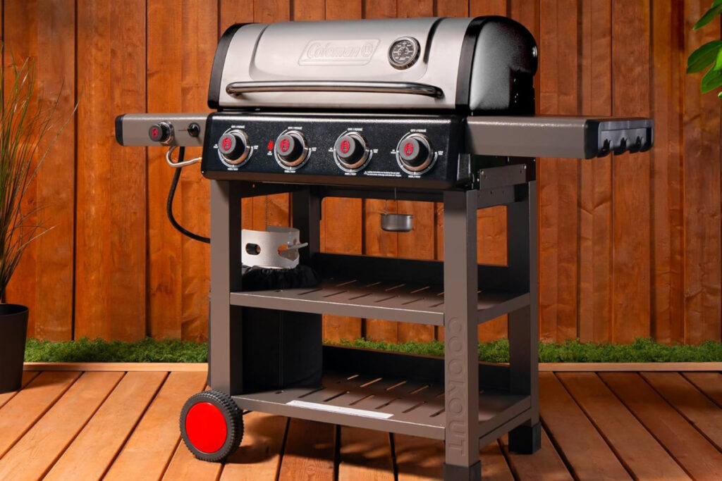 Coleman Cookout 4-Burner Propane Grill showcased outdoors, featuring a sleek design, multiple burners, and a spacious cooking surface, perfect for backyard barbecues and cookouts.