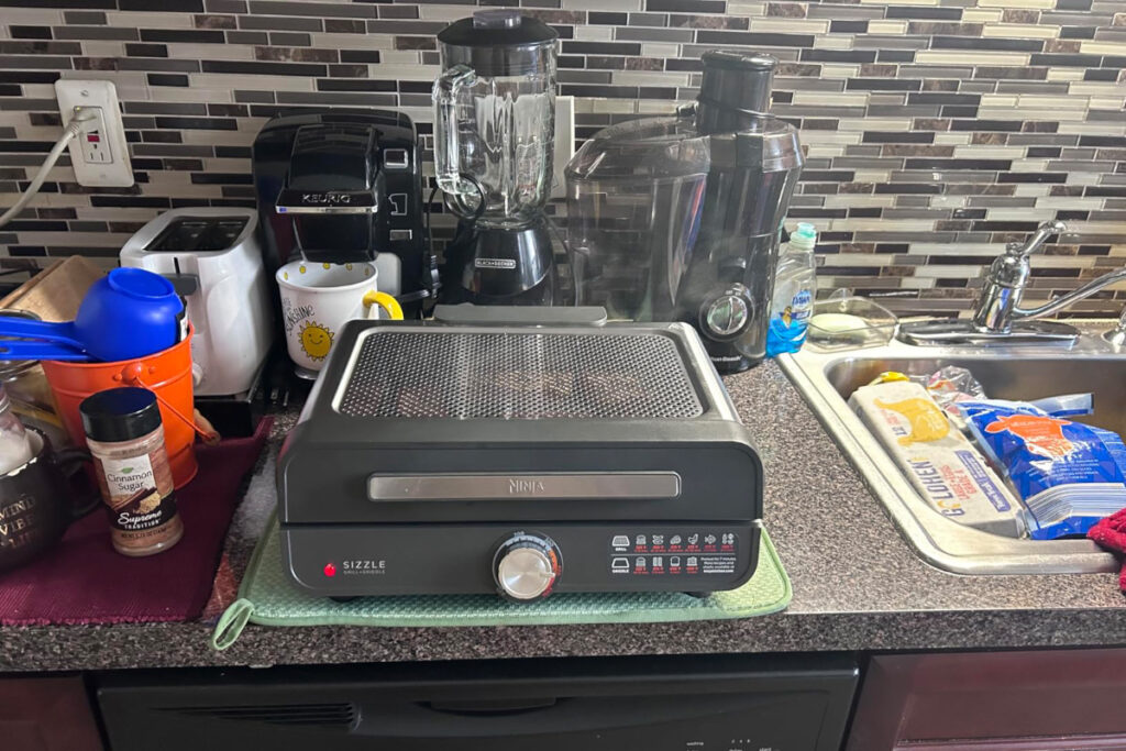 Ninja 14-inch Electric Griddle and Grill showcasing its versatile cooking surface, perfect for preparing pancakes, burgers, and more; featuring sleek design and easy-to-use controls.