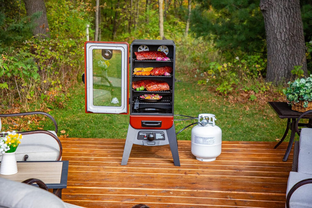 Pit Boss Grills PBV3G1 Vertical Smoker showcasing its durable design and spacious smoking racks, perfect for outdoor cooking enthusiasts.