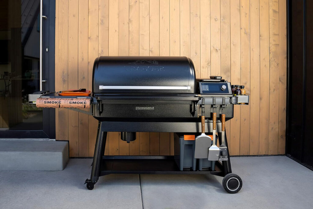 Traeger Grills Ironwood XL Electric Wood Pellet Grill and Smoker showcased in a backyard setting, highlighting its innovative features and sleek design for outdoor cooking enthusiasts.