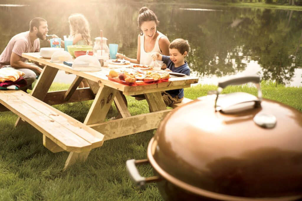 Weber Original Kettle Premium Charcoal Grill showcasing its sleek design and superior features in an outdoor setting, ideal for summer barbecues and grilling enthusiasts.