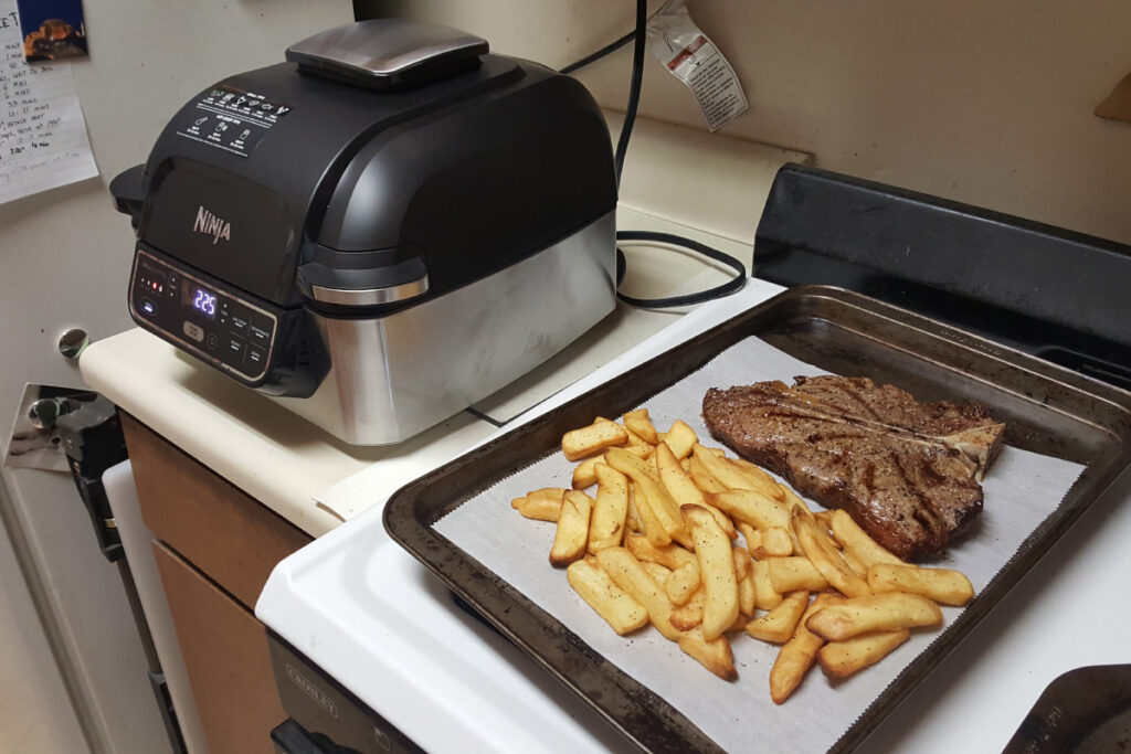 High-quality image of the Ninja AG301 Foodi 5-in-1 Air Fryer showcasing its versatile cooking features and sleek design, perfect for healthy meal preparation and multi-functional kitchen appliance needs.