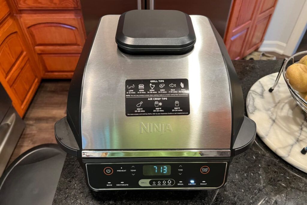 Alt text: "Ninja EG201 Foodi 6-in-1 Indoor Grill Feature Image showcasing a sleek, multifunctional indoor grill with six versatile cooking options for healthier, restaurant-quality grilled meals at home."